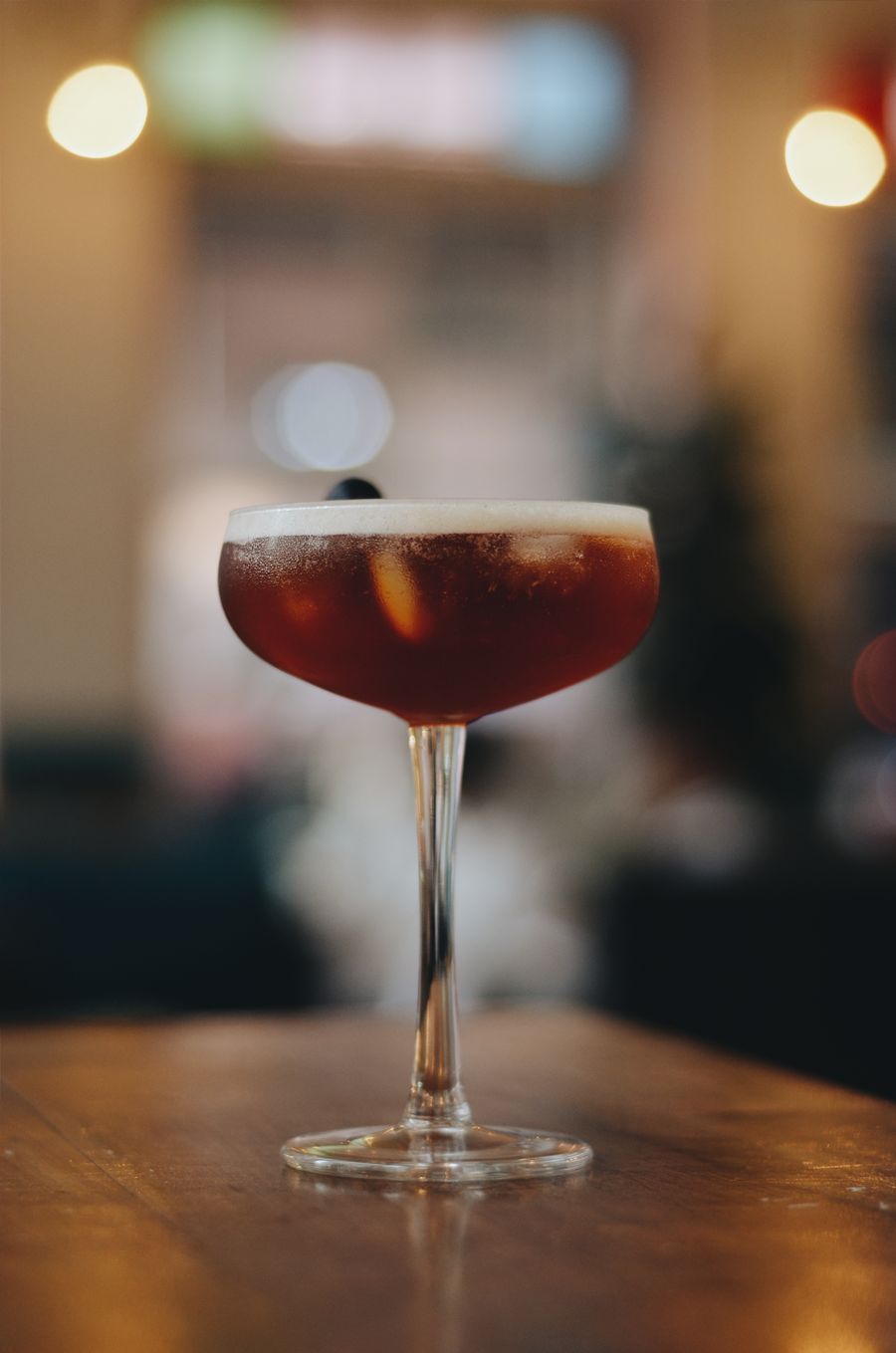 A dark stirred cocktail in a coupe glass