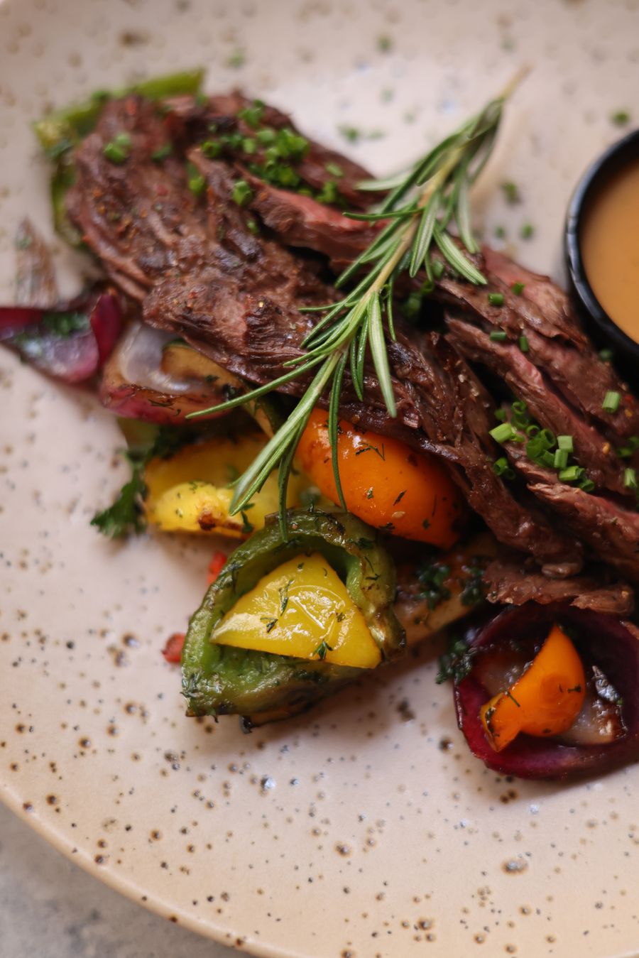 Grilled steak with peppers and rosemary