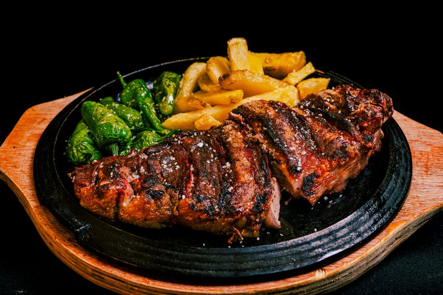 A sliced steak on a cast-iron skillet