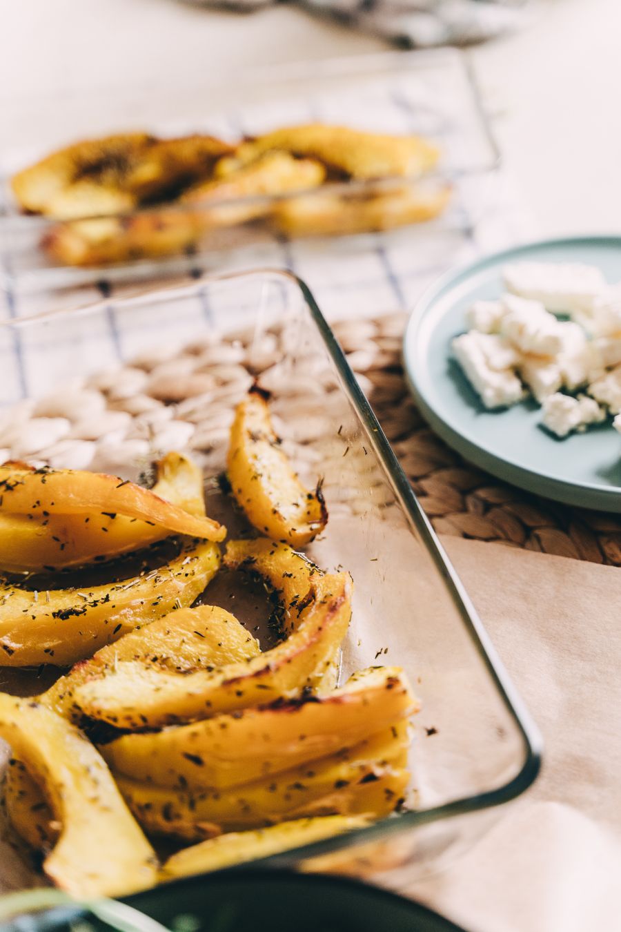 Roasted squash wedges on a dark board